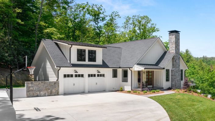 The exterior of a modern farmhouse with a two-car garage.